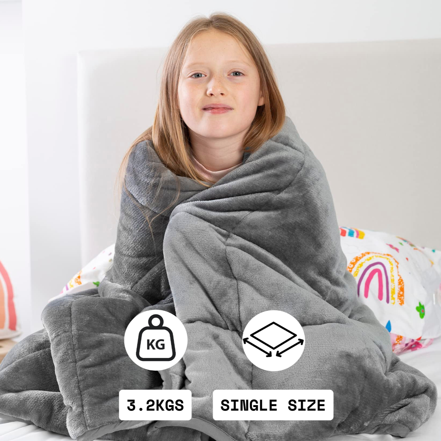 Child wrapped in a gray weighted blanket with weight and size indicators on a bed.