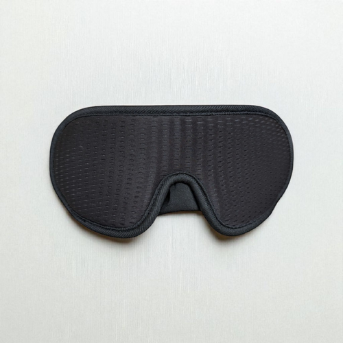 Black 3D sleep mask on a light grey background
