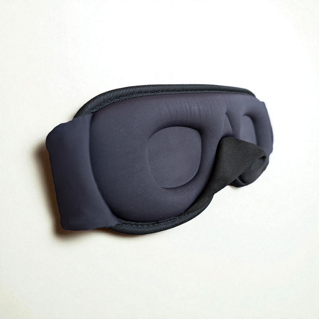 Dark grey 3D eye mask on a white background