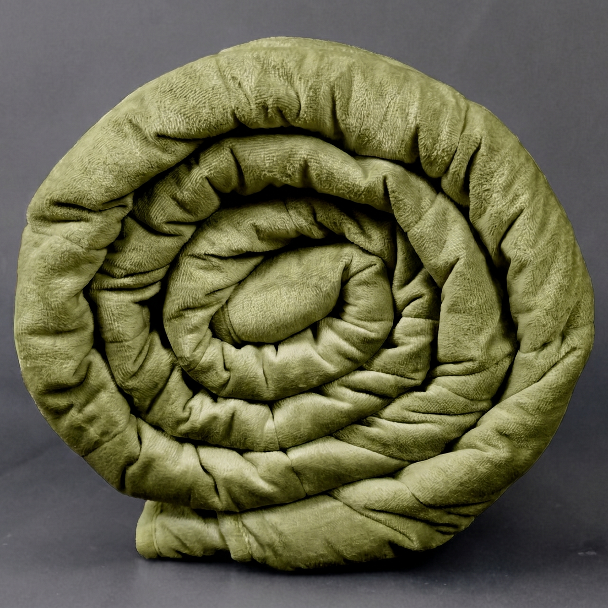 Rolled green weighted blanket on a gray background